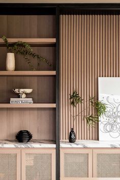 a book shelf with books and vases on it