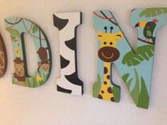 the letters are made up of wood and have animals on them