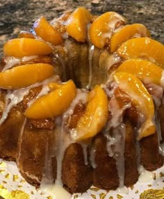 a bundt cake with oranges and icing on a plate