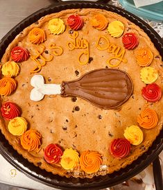 a cookie cake decorated with icing and decorations