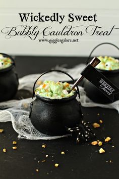 two black caulders filled with candy and sprinkles on top of a table