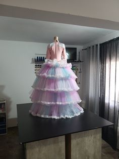 a dress made out of tulleries on top of a table in a room