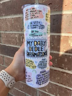 someone holding up a travel mug that says, my daily bible affirmations