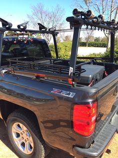 the truck is loaded with skis and snowboards on it's roof rack