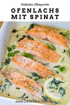 baked salmon with spinach and lemon in a white casserole dish on a wooden table