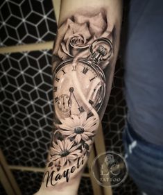 a person with a clock and flowers on their arm