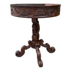 an ornate wooden table with carved carvings on the top and legs, against a white background