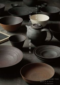 various bowls and plates are arranged on the floor with chinese characters written in large letters