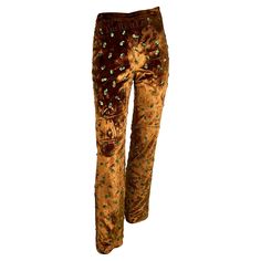 Presenting a pair of Dolce and Gabbana copper velvet embroidered pants. From the 1990s, these flare pants are constructed of lush copper velvet and are accented with beaded floral details throughout. Approximate measurements: Size - removed Waist: 28" Hips: 36" Inseam: 33" 80% viscose, 20% silk 90s Wardrobe, Vintage Wide Leg Pants, Daisy Jones, Embroidered Pants, The 1990s, Colour Palettes, Dolce & Gabbana, Dream Wardrobe, Flare Pants