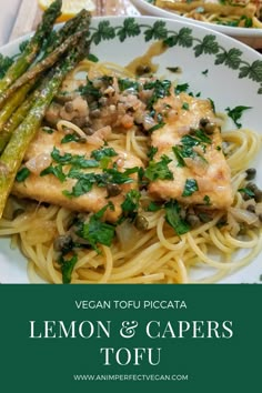 a white plate topped with pasta and asparagus