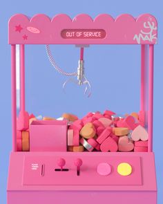 a pink gummy machine filled with lots of candy