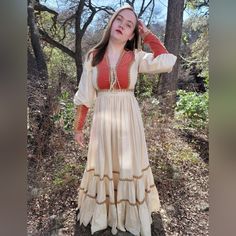 Just In Time For Fall The Most Dreamy Orange Velvet Gunne Sax Dress!! This Dress Is Literally Meant For Fall Photo Shoots With Beautiful Leaf Change Or Thanksgiving Feasts. I Have Only Seen This Dress One Other Time It Is A Very Special Dress And Hard To Find. The Velvet Is Such A Beautiful Burnt Orange Color And The Jute Natural Color Trim With The White Muslin Really Makes It Pop. The Dress Has The Classic Corset Style Bodice That Is Very Flattering. Multi Tired Skirt And Long Zipper Sleeves A Fitted Cream Maxi Dress, Peasant Style Fitted Dress With Long Sleeves, Peasant Style Midi Dress For Fall, Peasant Long Sleeve Fitted Dress, Peasant Style Long Sleeve Fitted Dress, Elegant Fitted Long Sleeve Peasant Dress, Peasant Style Maxi Length Prairie Dress, Fitted Beige Peasant Dress, Fitted V-neck Peasant Dress