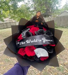 a woman holding a bouquet of flowers with the words the world is yours on it