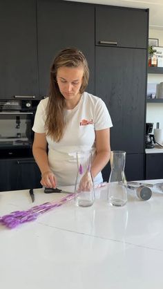 a woman is making something with purple paint