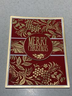 a red and gold christmas card sitting on top of a table