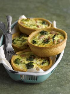 four mini quiches with broccoli and cheese in a basket