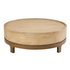 a round wooden table sitting on top of a white floor