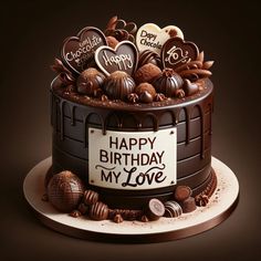 a chocolate birthday cake with lots of heart shaped candies