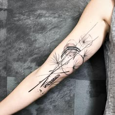 a woman's arm with a dandelion tattoo design on the left forearm