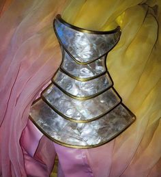 a dress made out of metal and pink fabric