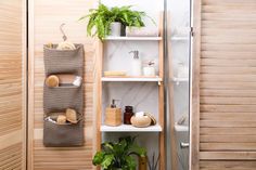 a bathroom with wooden shutters and shelves filled with toiletries