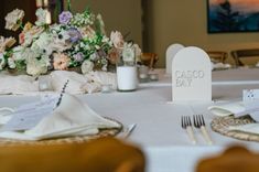 the table is set for a wedding reception with place settings and napkins on it