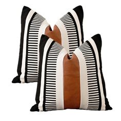 two black and white pillows with brown stripes