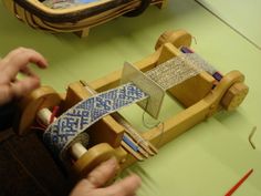 a person is working on a wooden toy