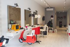 a salon with chairs, mirrors and lights