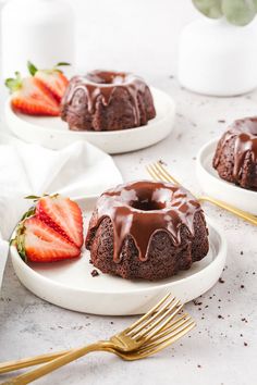 chocolate bundt cake on two plates with strawberries