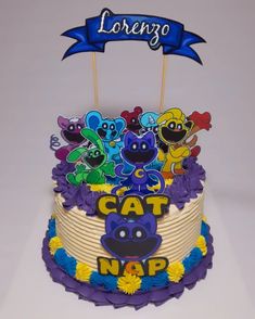 there is a cake decorated with cartoon characters on the top and blue ribbon that says cat nap