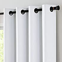 white curtains hanging on the side of a window in front of a window with an open curtain rod