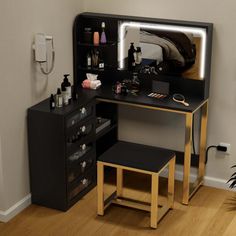 a black vanity with mirror and stool in a room