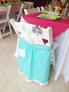 the table is covered with pink and blue cloth