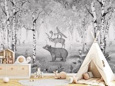 a child's room with a teepee tent and wall mural depicting animals in the woods