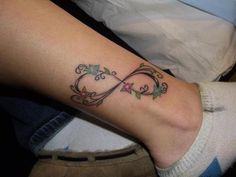 a woman's foot with a tattoo on it that has an infinite symbol in the middle