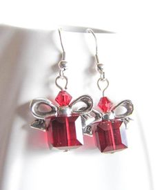 Beautiful, red cube beads are topped with a silver plated bow just like a Christmas present. Give the Christmas spirit as a gift or keep the earrings for yourself! Great as stocking suffer too! The earrings are 1.25in long (3.5cm) with Surgical steel fishhook earwire. For larger selection you can visit my shop: http://www.etsy.com/shop/EvaLineJewelry?ref=si_shop Holiday Gift Dangle Earrings, Holiday Dangle Earrings For Gifts, Dangle Earrings As Holiday Gifts, Dangle Earrings For Holiday Gift, Red Christmas Jewelry Gift, Red Jewelry Christmas Gift, Red Jewelry For Christmas Gift, Holiday Dangle Jewelry Gift, Holiday Dangle Jewelry For Gifts