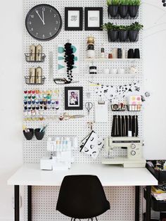 a white desk topped with a sewing machine and lots of crafting supplies on it