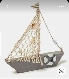 a small boat made out of concrete with a rope