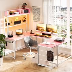 a home office with two computer screens and a pink desk