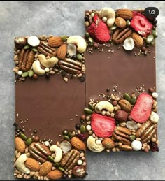 two pieces of chocolate with nuts and strawberries on top