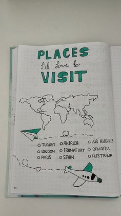 an open notebook with the words places to visit written in green and black on it