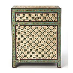 an ornately decorated cabinet with two drawers and one drawer on the bottom, is shown