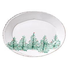 a white plate with green trees painted on the side and red berries in the middle