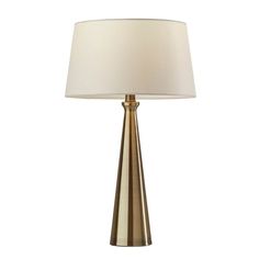 a table lamp with a white shade on it and a gold metal base, against a white background