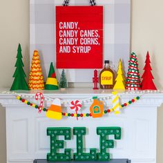 a christmas mantle decorated with candy canes, candy corns, and syrup bottles