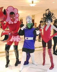 three people dressed in costumes standing next to each other