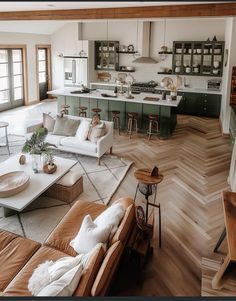 a living room filled with furniture next to a kitchen and breakfast nook in a home