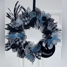 a black and white wreath with a jack skellingy face on the front door