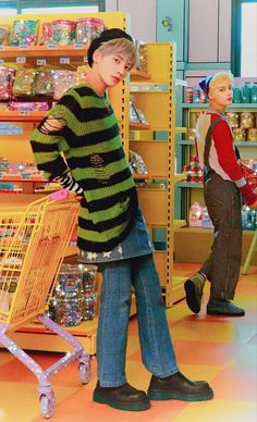 two young boys standing next to each other in front of a store display with shopping carts